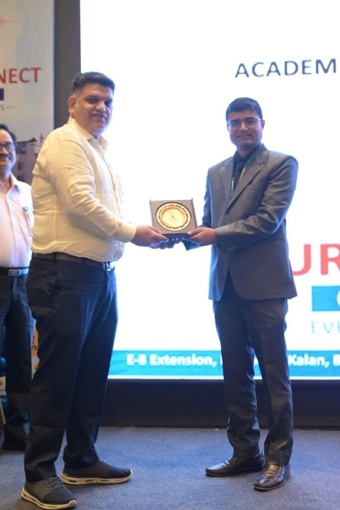 Dr Nishant Kumar Shukla receiving an award at stage